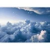 Artgeist Fototapetas - Aerial Landscapes: Rays Lighting Up Fluffy Cloud Formations