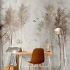 Artgeist Fototapetas - Among the trees - landscape in pilkas tones in fog in a clearing with birds