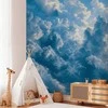Artgeist Fototapetas - Ocean in the Air: Waving Clouds Reflecting Morning Light