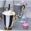 Diana auksinis porcelianinis puodelis 300 ml AMBITION juostelės