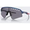 Oakley „Sutro Lite Sweep“ dviratininko akiniai – šviesiai mėlyni, perjungiami su perėjimu prie šviesos / prizminiai pilki