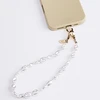 UNIQ Coehl Perla Handstrap universal phone strap for hand baltos spalvos/baltos spalvos pearl