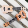 Mini ukulele žaislas vaikams, plastikinis gitaros žaislas, 4 stygos, muzikos instrumentas, realistiškas modelis, 25 x 9 x 2.7 cm, šviesiai ruda