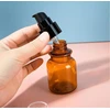 2 pakuotės 100 ml kelioninių buteliukų tualeto reikmenims, gintaro spalvos plastikas, mini muilo dozatorius, losjono pompa, kosmetikos indelis, buteliukas su juoda pompa eteriniams aliejams, mišiniams