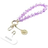 Dėklas Guess universalus riešo dirželis su kristalais 4G Charm violetinis