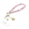 Guess Universal Wrist Strap Crystals 4G Charm rožinės spalvos