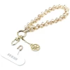 Dėklas Guess Universal Wrist virvelė Crystals 4G Charm aukso spalvos
