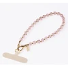 UNIQ Coehl Candy Gem Handstrap universali virvelė skirta telefonui ant rankos rožinės spalvos candy