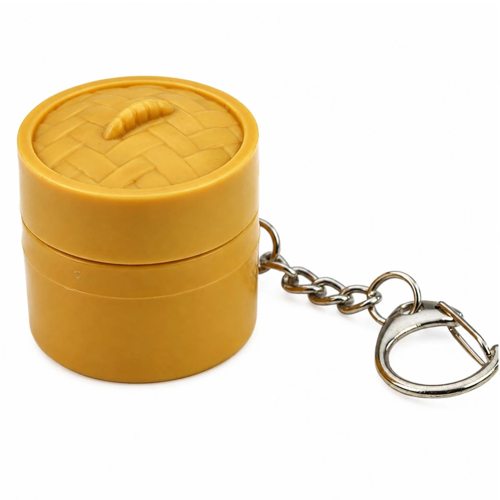 Lean Toys Raktų pakabukas su šviečiančiu koldūnu ir atverčiamu dangteliu, 3,5 × 3,5 cm