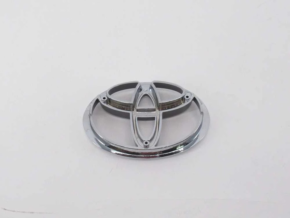 AUTENTIŠKAS TOYOTA 4RUNNER TACOMA T100 PICKUP PRIEKINIS GROTELIŲ CHROMO EMBLEMA 75311-35090