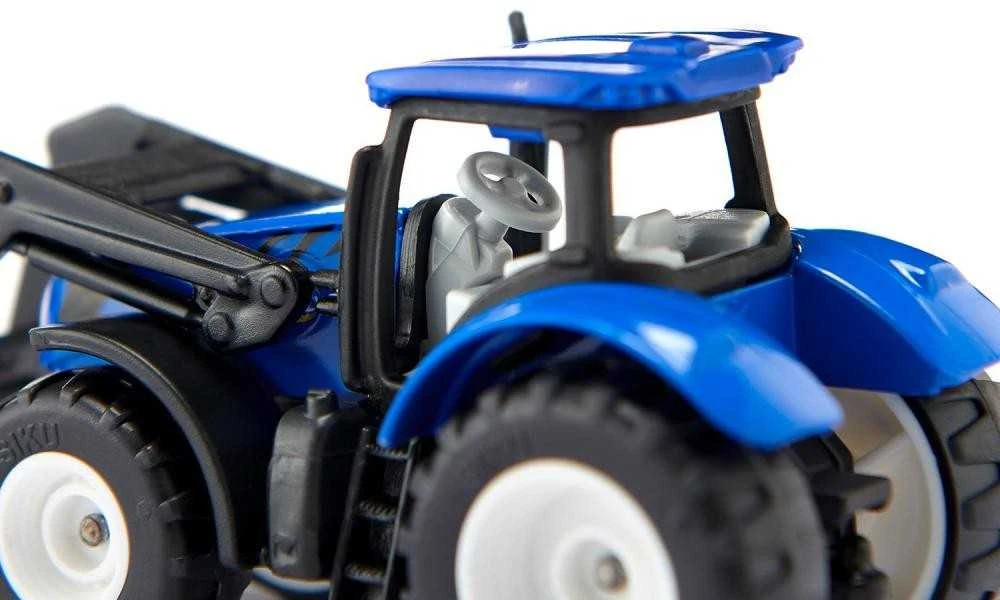 Siku Traktorius su šakėmis ir New Holland padėklais