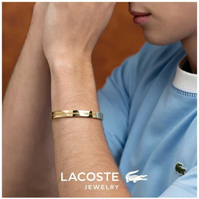 Lacoste Nuotykių ieškotojo paauksuota plieninė atvira vientisa apyrankė 2040527