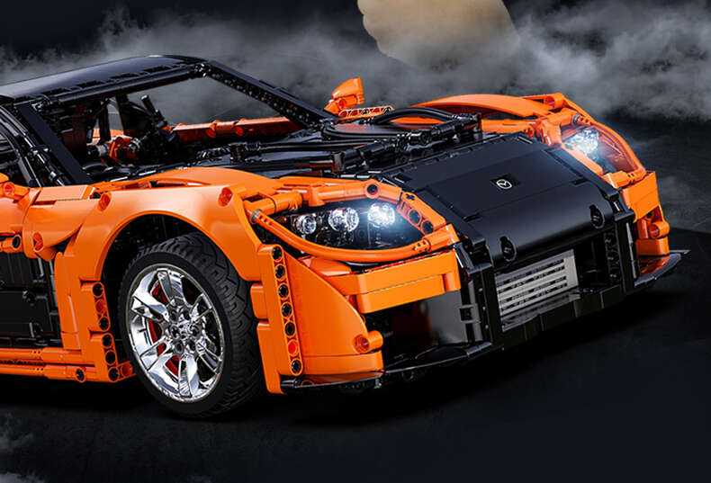 CaDA statybiniai blokai Nuotoliniu būdu valdomas automobilis 56 cm oranžinės spalvos automobilių lenktynės Mazda RX-7 3305 dalys RC