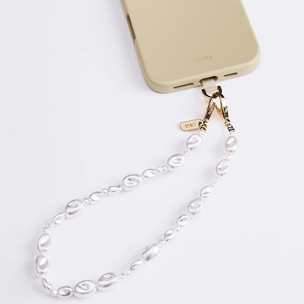 UNIQ Coehl Perla Handstrap universal phone strap for hand baltos spalvos/baltos spalvos pearl