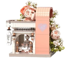 Jokomisiada Kaladėlės Rose Meet Wedding Hall su gėlėmis ir suknele