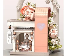Jokomisiada Kaladėlės Rose Meet Wedding Hall su gėlėmis ir suknele