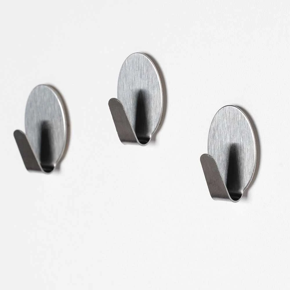 Orion Plieniniai klijuojami kabliukai 1,8x2,5 cm - universalūs
