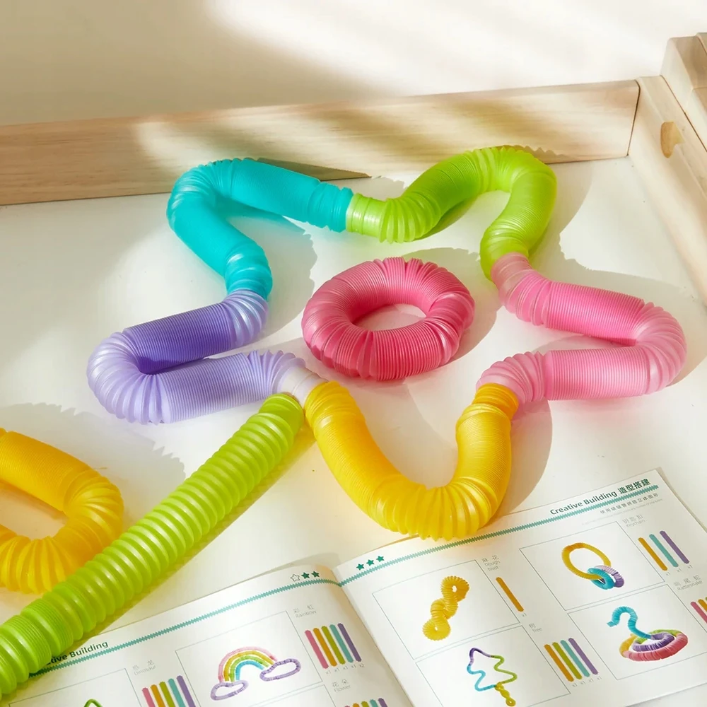 Glow Pop spyruoklės, jutimo vamzdeliai, skirti tempti ir švytinti mideer kamuoliukus