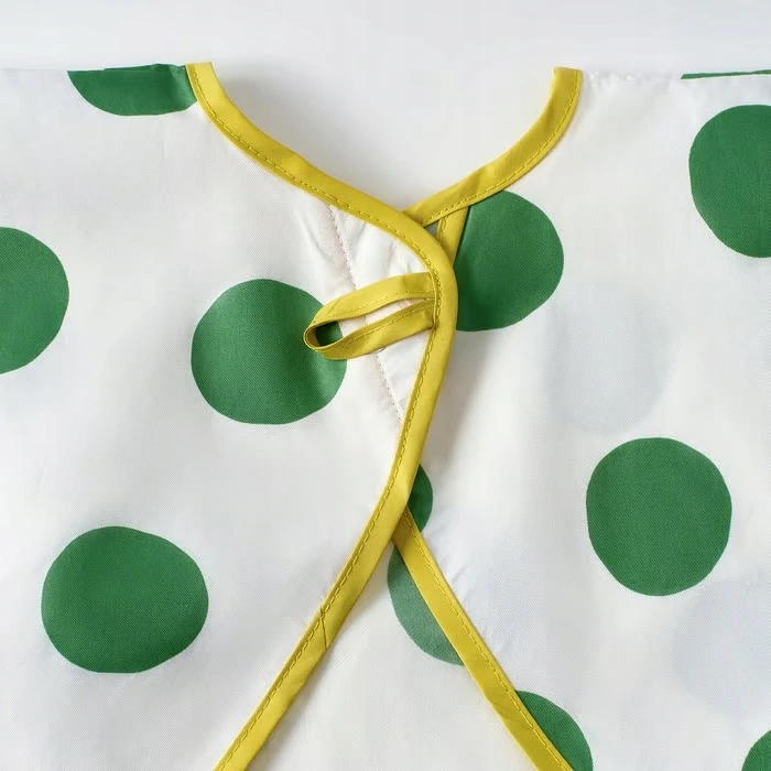 IKEA KLADDIG Prijuostės seilinukas su rankovėmis, baltais ir žaliais taškeliais