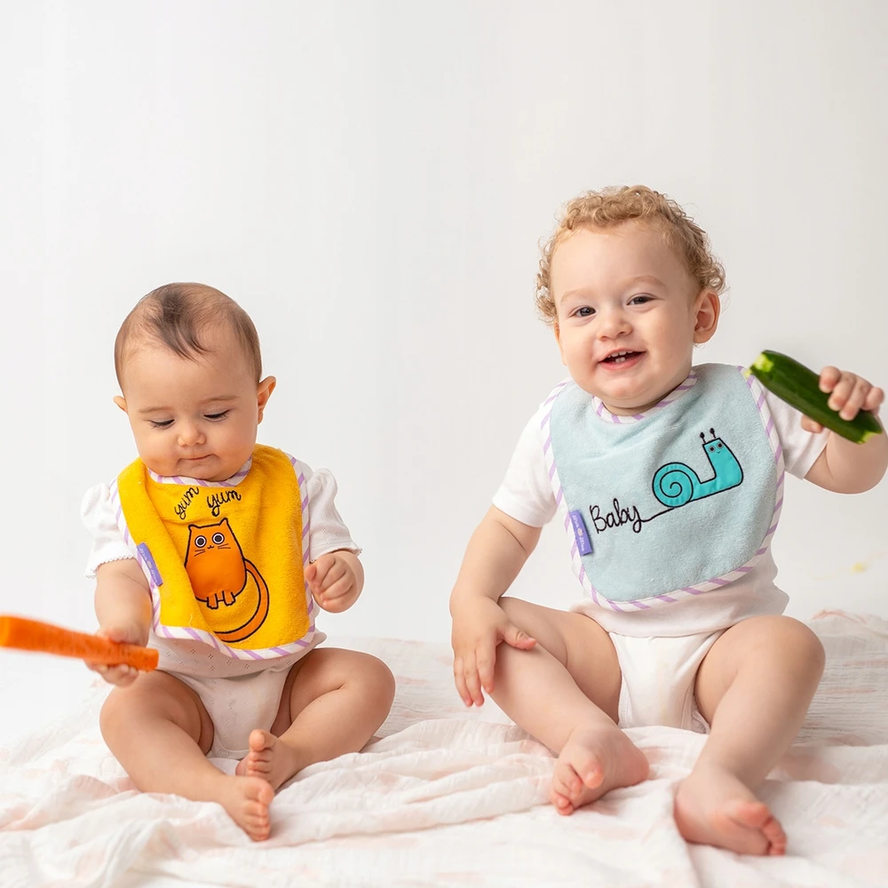 Milk&Moo medžiaginis seilinukas Mėlynos ir geltonos spalvos atspalviai 2 vnt.
