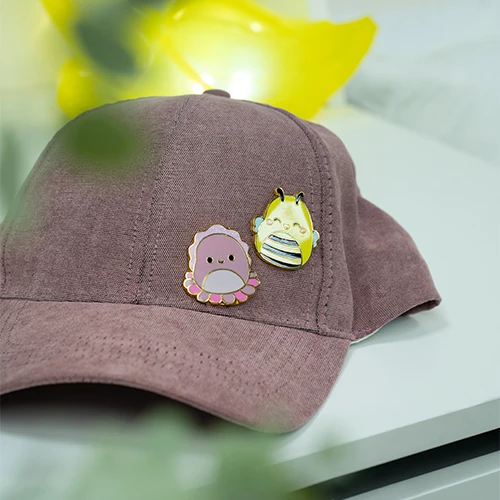 „Squishmallows“ – 2 ženkliukai „Sunny Auggie“ – ryškios