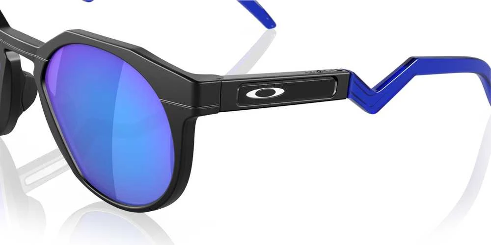 Oakley HSTN akiniai mėlynais lęšiais ir lenktomis kojelėmis