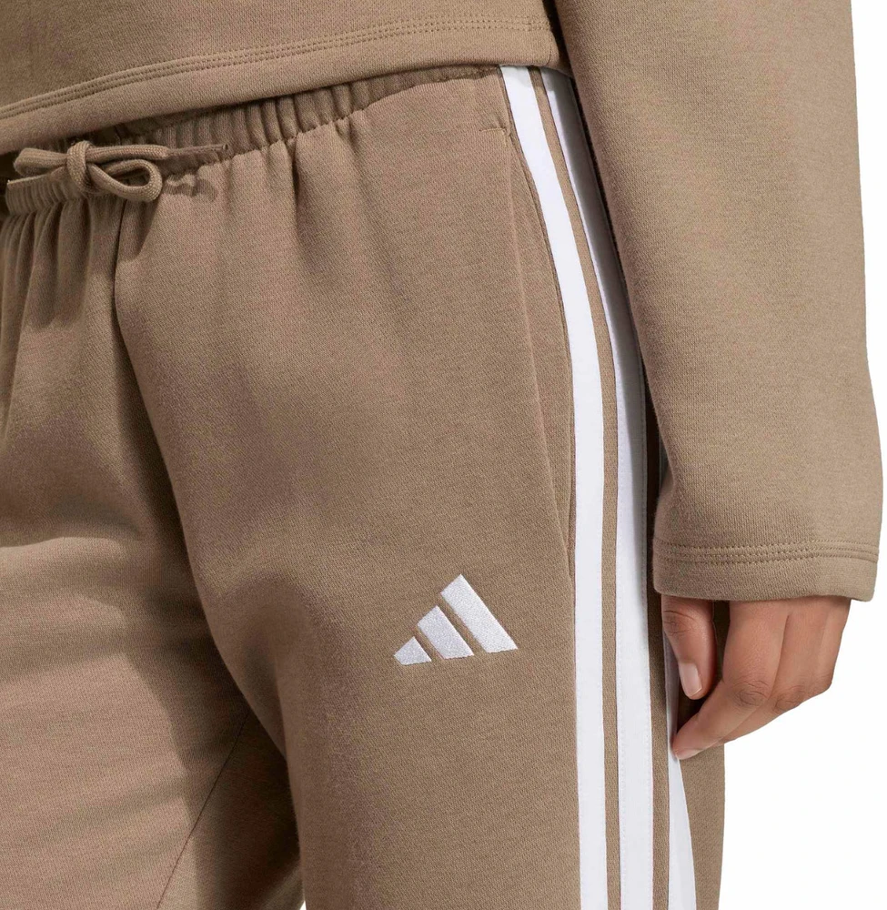 Kelnės moterims adidas Essentials 3-Stripes Fleece Slim smėlio sp. KF8317 (L)