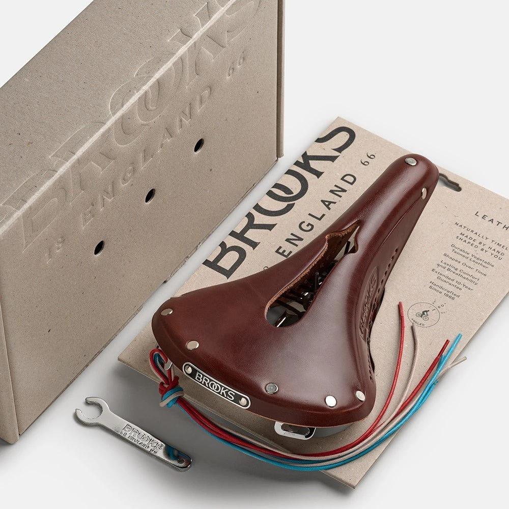 Brooks Balnelis BROOKS B17 CARVED, rudos spalvos, plieniniai lankeliai, svoris 520 g, linija Leather