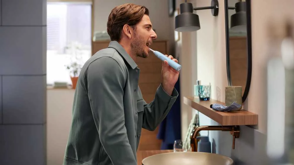 Mėlynas Philips Sonicare elektrinis šepetėlis naudojimo metu