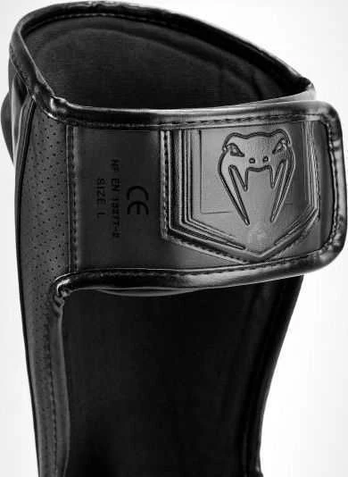 Venum Elite Evo blauzdų apsaugos, juodos/juodos