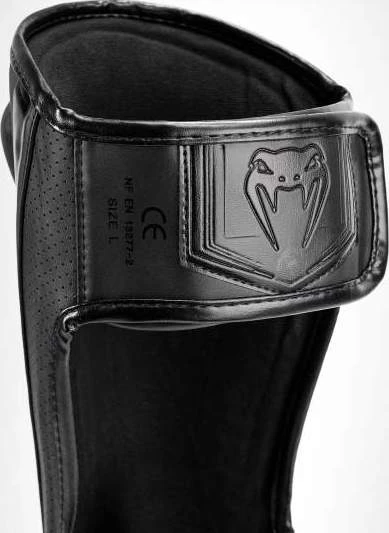 Venum Elite Evo blauzdų apsaugos, juodos/juodos